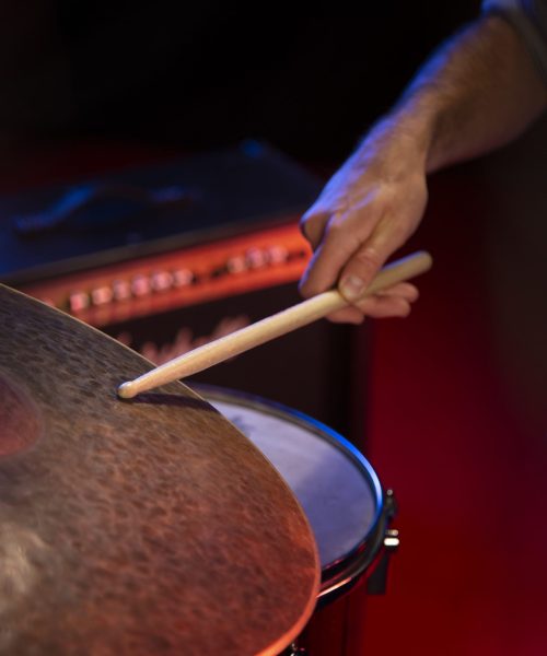close-up-hand-holding-drum-stick